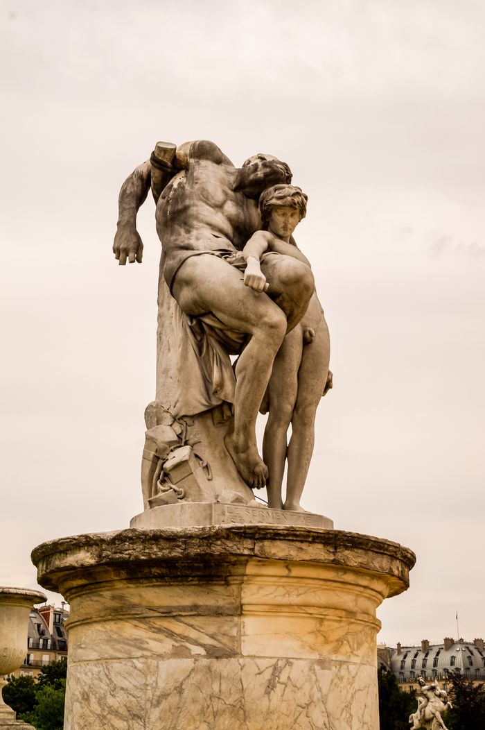 Elegant marble statue captured in Paris, showcasing intricate art and craftsmanship.